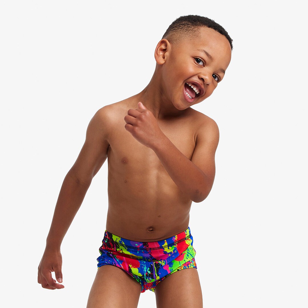 Boy wearing swimming trunks hotsell